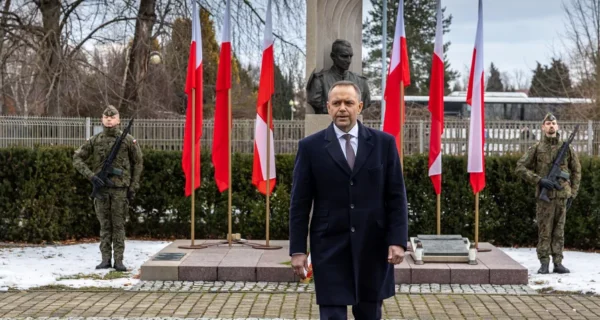 Prezydent RP Karol Nawrocki składa wieniec przed pomnikiem rotmistrza Witolda Pileckiego w Oświęcimiu, w asyście żołnierzy Wojska Polskiego i przy biało-czerwonych flagach.