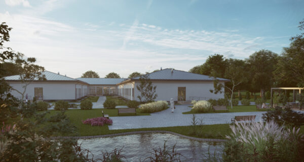 Wizualizacja ośrodka „Opiekuńcze Skrzydła” w Jawiszowicach – nowoczesny kompleks z zielonym dziedzińcem i alejkami, planowany dla osób z niepełnosprawnościami wymagających całodobowej opieki